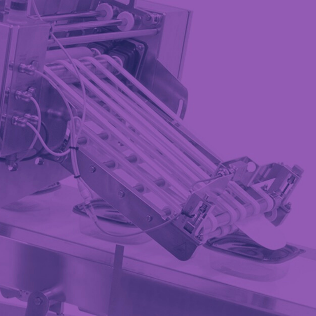 Tipping Application: Friction feeder tipping labeler cards onto meat containters